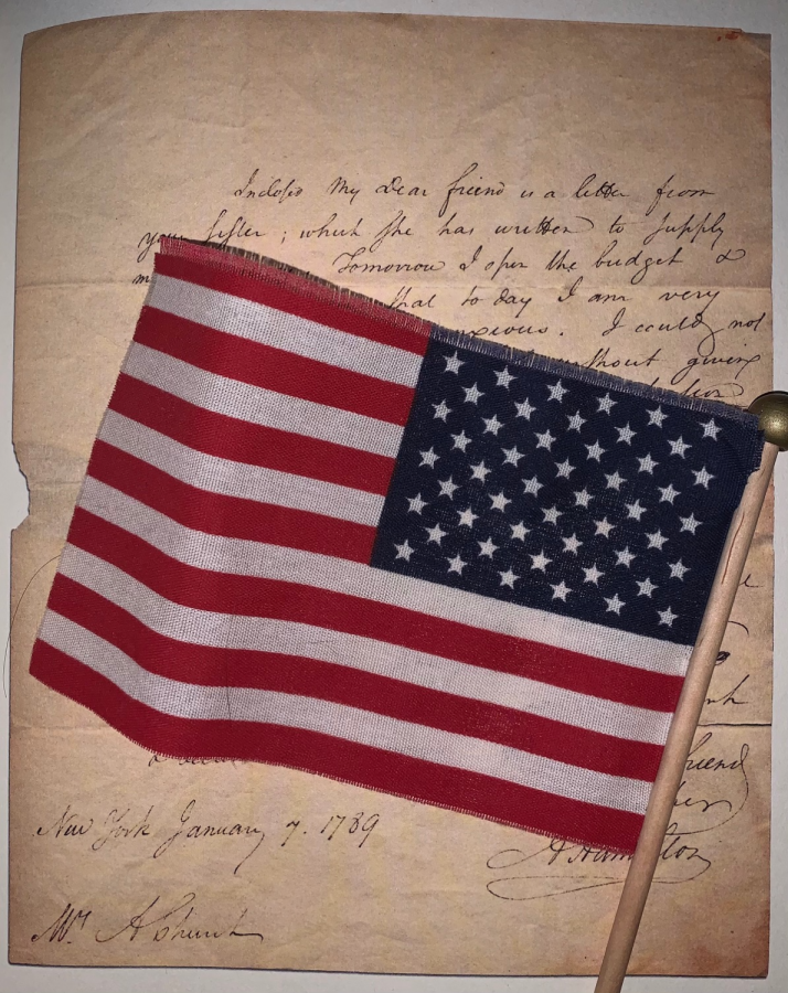 An American flag looms over a primary source document, one that is similar to documents that Bronx Science students analyze in their Advanced Placement American Studies classes.