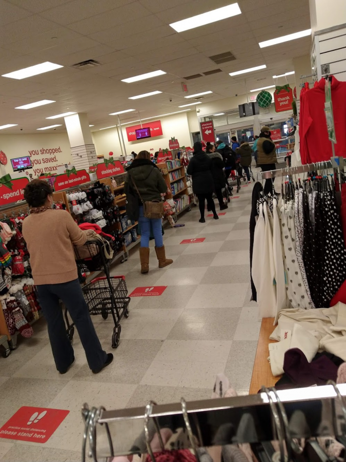 T.J. Maxx customers try their best to socially distance while waiting in line to purchase their items in December 2020, during the Coronavirus pandemic. 
