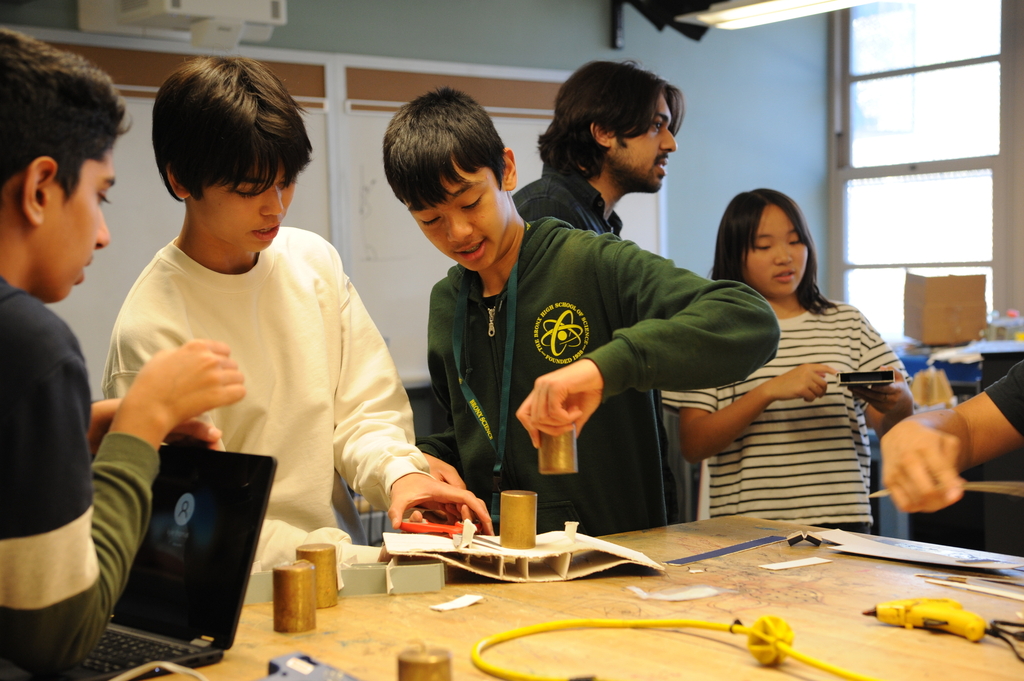 Students experiment with designing a bridge, and determining how much weight their creation can support. 
