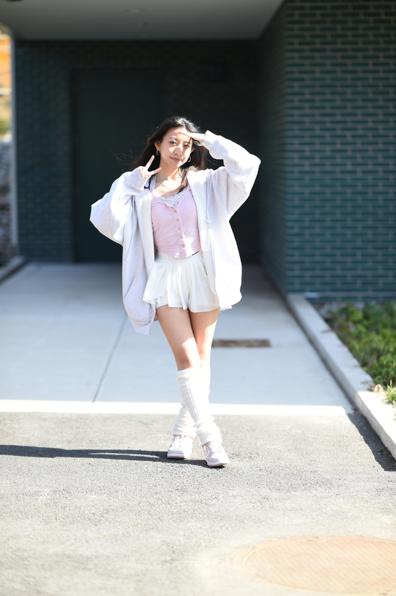 Eva Wang ’24 wears one of her essentials, a zip-up hoodie, in order to combat the cold weather she has to endure, while still looking stylish.
