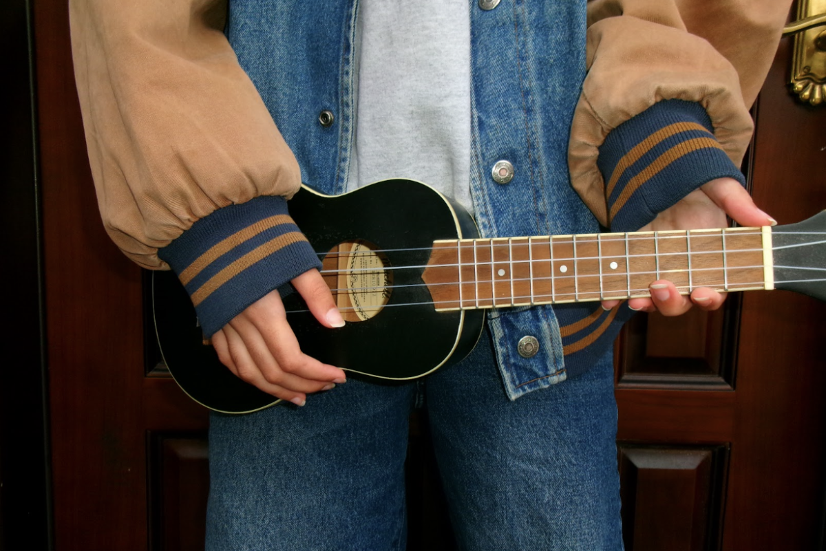 Here is my sister, Ameena Khan, showing off her new ukulele, wearing her favorite blue denim jacket and jeans.