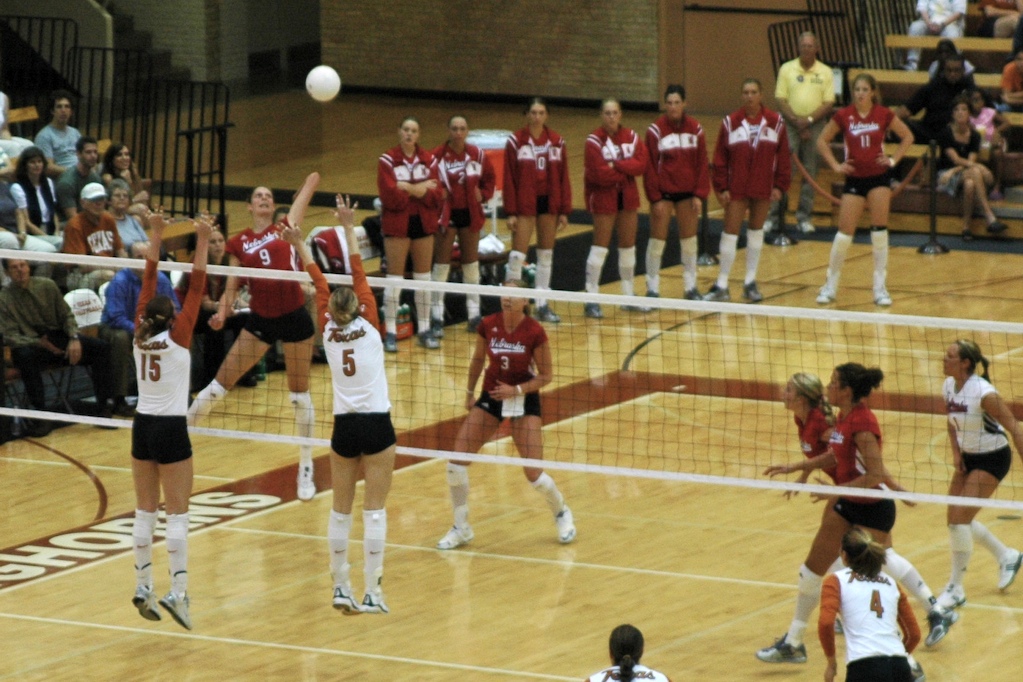 Sarah Pavan, a former Husker on Nebraska’s 2006 game, is hitting against a tough Texas block. 2006 was the year in which Nebraska won their third championship title under current coach John Cook. (Photo Credit: CC BY-SA 3.0, https://commons.wikimedia.org/w/index.php?curid=96193901/Wikimedia Commons)