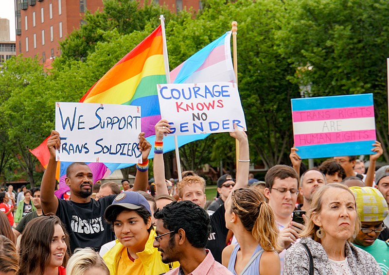 Protesters fought to stop the transgender military ban in 2017. President Trump just tried to reinstate the ban, but it has been blocked by a federal judge in an ongoing saga of legal battles. (Photo Credit: Ted Eytan, CC BY-SA 2.0 , via Wikimedia Commons)
