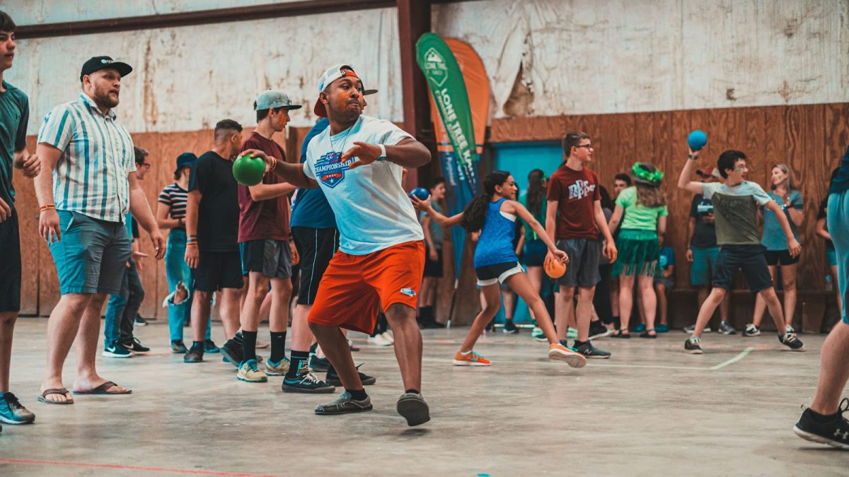 As these players unite on the dodgeball court, they demonstrate that skills like collaboration and perseverance hold value at any age. (Photo Credit: Anderson Schmig / Unsplash)