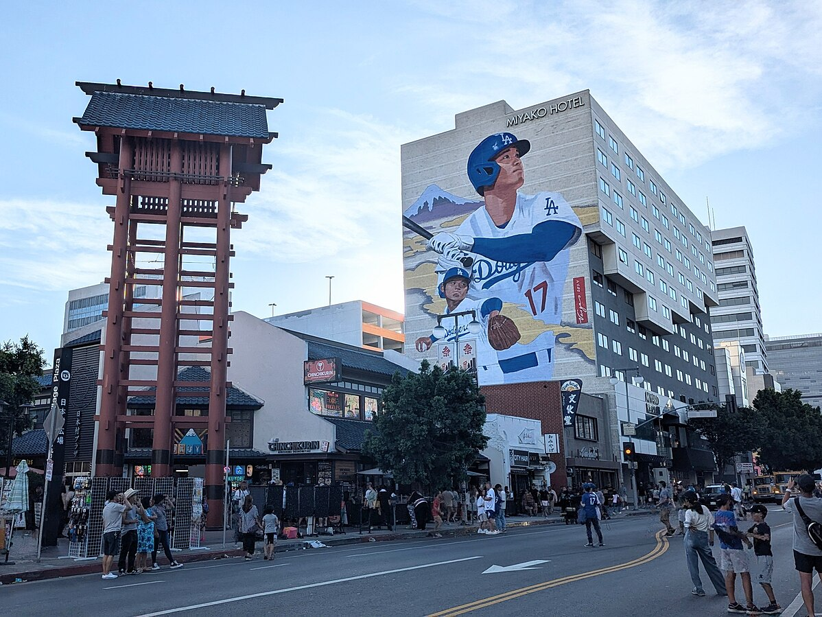 Pictured is a mural of Shohei Ohtan, which stands tall on a building in Little Tokyo, Los Angeles. (Photo Credit: Haha169, CC BY 4.0 , via Wikimedia Commons)